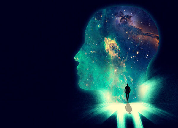 Illustration of a man walking towards a huge shape of a person's head overlaid with an image of the cosmos